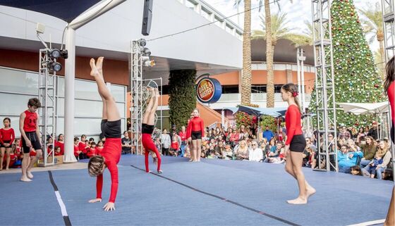 Tumble Masters gymnasts performing handstands together at a holiday show