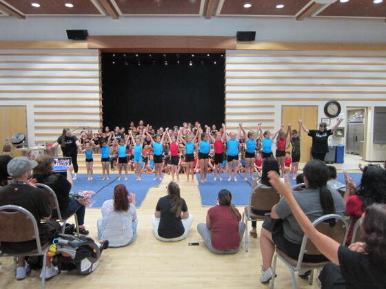 The full Tumble Masters group on stage in front of an audience