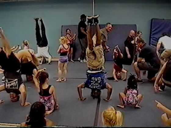 Dads and kids doing handstands together