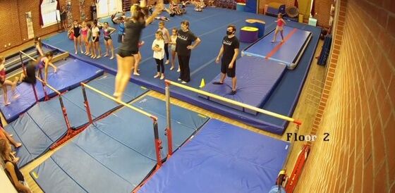 Practicing bar routines in the new gym