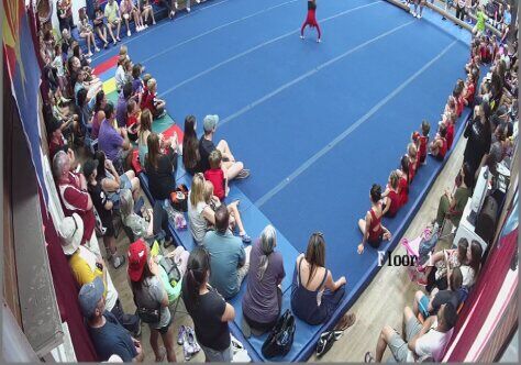 A handstand in front of a packed gym, 2023